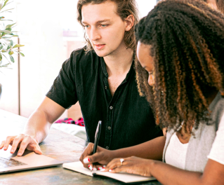 Two people working together in a computer